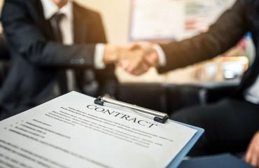 Close-up of business contract with pen at workplace on backgroun